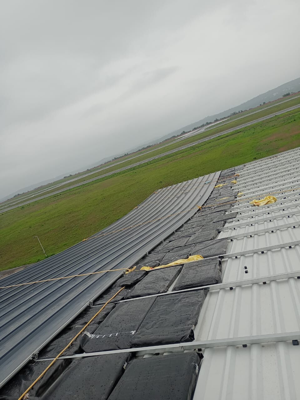 Commercial architectural roofing at Oberoi Mall, Mumbai: Specialized Kliplok roof-on-roof installation by Rishonn & Reyansh for leak-proof retail infrastructure.